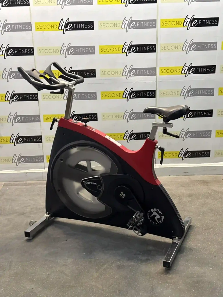 A close-up shot of the BODY BIKE Supreme Red's robust frame and smooth flywheel, showcasing the high-quality construction and engineering designed for lasting performance in demanding UAE fitness environments, whether private or commercial.